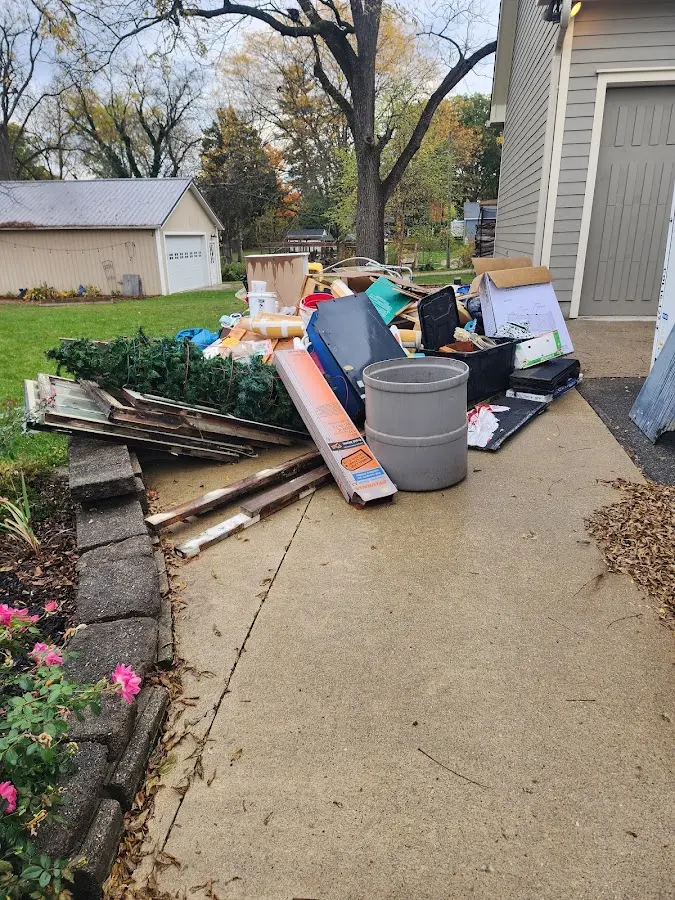 Dumpster being loaded with debris for 12 Yard Dumpster Rental in Belfair